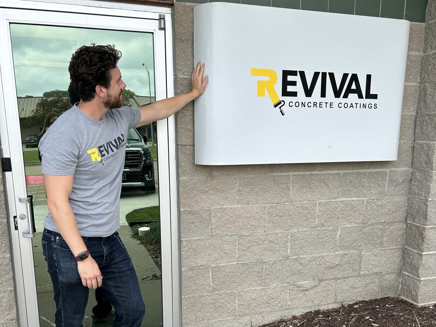 Jack Forsman at the Revival Concrete Coatings office sign